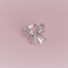 It's a ribbon ring that designed like a ribbon wrapped in a gift with a bulky broad cord. Give yourself this lovely cute ribbon ring! ● Production time for all orders is 4-8 business days. ● We offer FREE jewelry box. *Due complications from Covid-19, delivery dates may take longer than the usual depending on country of your residence. KAELUS is the leading brand of South Korean Silver/Gold Jewelry design. We aim to expand our brand globally with the best quality in the market. Follow us to see Tie Ring, Ribbon Ring, Cute Ribbon, Cute Ring, Silver Gold Jewelry, Bow Ring, Rings Jewelry Fashion, Ring Fashion, Holiday Jewelry