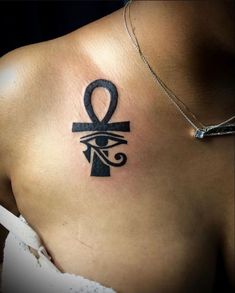 an egyptian symbol on the back of a woman's shoulder