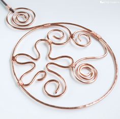 an image of a necklace made with copper wire and spirals on the front side