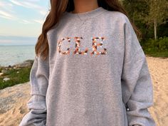 Custom letter embroidered crewneck sweatshirts! - You can request a school abbreviation, a city name, greek letters, a name, sports teams, or anything else you may want! If you have any questions, want to request a different sweatshirt color than offered, or are interested in a bulk order discount, please reach out to me! Embroidered Flower Sweatshirt, Flower Sweatshirt, Letter Sweatshirt, Act Like A Lady, Embroidery Letters, College School, College Gifts, Embroidered Crewneck, Greek Letters