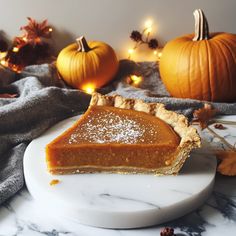 a slice of pumpkin pie sitting on top of a white plate