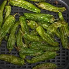 some green peppers are sitting on a grill