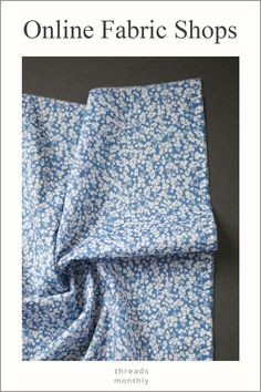 a blue and white flowered fabric with the words online fabric shops written in black