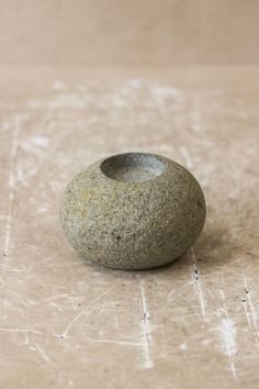 a rock sitting on top of a wooden table