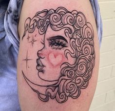 a woman's face with curly hair and a heart on the side of her thigh