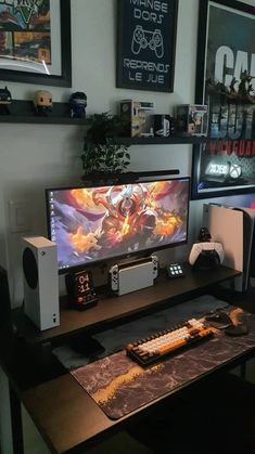 a desk with a monitor, keyboard and speakers on it