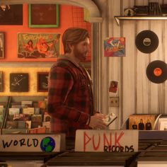 a man standing in front of a record store with vinyl records on the wall behind him