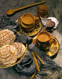 two cups of tea and some cookies on a table