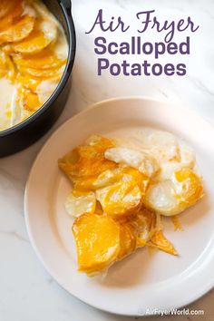 an air fryer is sitting next to a plate with potatoes and other food on it