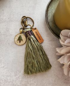 a tasseled keychain with a tree on it