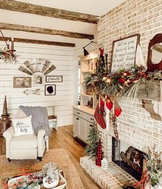 a living room decorated for christmas with stockings and stocking on the fireplace mantel