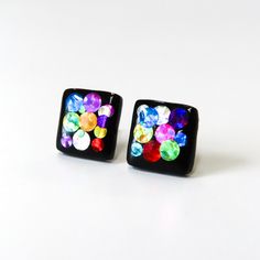 Fun and colorful black square studs with flashy glitter in reds, pinks, blues, yellows and other rainbow colors.  Hard resin finish brings out all the ranges of color with each change in direction.  Hypoallergenic titanium posts, excellent for sensitive ears.   Squares measure 10mm. // Info: * Titanium posts * 100% Nickel-free * Hypoallergenic for sensitive ears * Hand sculpted, ultra lightweight We always include a pair of spare silicone backings with each order! Other colors in this section of Multicolor Rectangular Earrings For Party, Square Multicolor Earrings For Gift, Cheap Black Resin Earrings, Cheap Multicolor Resin Earrings, Black Hypoallergenic Resin Earrings, Handmade Multicolor Square Earrings, Epoxy Stud Earrings, Square Stud Earrings, Black Rainbow