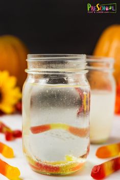 two jars filled with candy sitting on top of a table