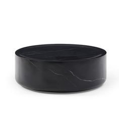 a black marble coffee table sitting on top of a white floor