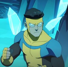 an animated man in a yellow and blue outfit holding his fist up while looking at the camera