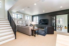 a living room with stairs leading to the second floor