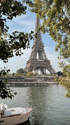 the eiffel tower towering over the city of paris from across the river seine