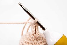 a ball of yarn with a crochet hook in the middle and a knitting needle sticking out of it