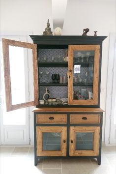 a black and wood china cabinet with glass doors