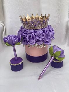 a purple hat with flowers on top and a pen in the middle next to it