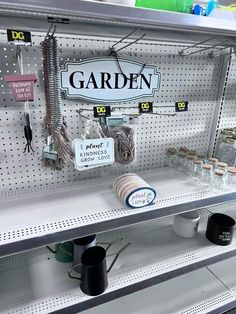 there are many items on the shelf in this store that is selling garden products and other things