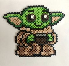 an image of a star wars yoda bead pattern on a white table top