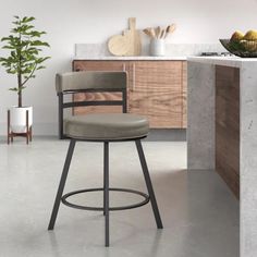 a kitchen with a counter, stool and potted plant in the corner next to it