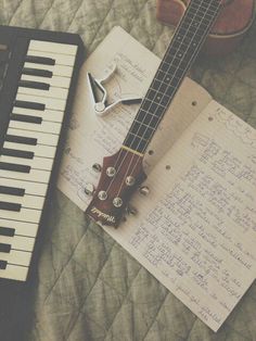 an electric guitar sitting on top of a sheet music