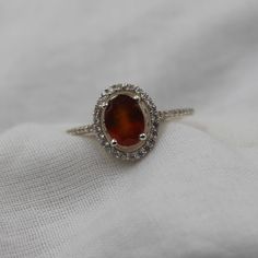 Handmade Product Description Gemstone : Natural Hessonite Garnet Stone Size : 6x8 MM Stone Shape : Oval Secondary Stone : Cubic Zirconia Gemstone : Cut Ring Size : All Size Available Band Color : Silver Made In (INDIA) Payment Policy We accept payment through PayPal Payment should be made within 3 days of purchase. Delivery Time It is Handmade Item So Item will be Shipped within 3 to 5 Days after payment receive. The delivery time usually takes 11 to 24 days, depending which Country & location. We recommend you contact your local customs office if you have questions about this. Feedback If you are not satisfied with your purchased items then contact with us first before leaving negative or neutral feedback or opening disputes. We believe in solving the issues. A positive feedback represent Sterling Silver Wedding Gemstones, Sterling Silver White Gold Gemstones For Wedding, White Gold Sterling Silver Gemstones For Wedding, Sterling Silver Accented Gemstones For Wedding, Wedding Amber Topaz Ring In Sterling Silver, Sterling Silver Wedding Birthstone Gemstones, Wedding Birthstone Gemstones In Sterling Silver, Sterling Silver Amber Birthstone Rings, Heirloom Sterling Silver Ring With Halo Design