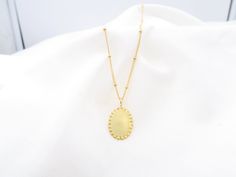 ✦ REALLY HANDMADE HIGH QUALITY // FULLY DESIGNED AND MADE IN PARIS 18K solid gold 15mm oval disc hammered pendant Necklace, textured Disc Pendant, Tiny Gold Disc, tiny handmade medallion 15 MM  Chose between :  👉 GP is : 18K gold plated over silver 925 (vermeil) 5 Micron is the highest degree of plated (rose or yellow) 👉Solid 18K: high quality recycled solid gold metal 18K 👉Sterling silver 925 recycled * Type : Necklace with dainty pendant,disc * Material (chain & pendant) : Strong Quality Gold over silver (vermeil) * Length : 38/42/45/50 with 5cm adjustable 5 cm chain on top  * Thickness of the chain : 1mm and Spring ring closure * Necklace on picture is 45 cm * Handmade in Paris  * All designs and personalization is done ✦ BY HAND ✦  in Paris :-) * Ethically Sourced materials, recycle Gold Oval Pendant Coin Necklace As Gift, Oval Hammered Necklace As Gift, Tarnish Resistant Oval Pendant Medallion Necklace Gift, Oval Hammered Necklace For Gift, Hammered Oval Yellow Gold Necklace, Hammered Yellow Gold Oval Necklaces, Elegant Hammered Oval Necklace, Gold Brass Necklace With Oval Pendant, Gold Hammered Oval Pendant Necklace