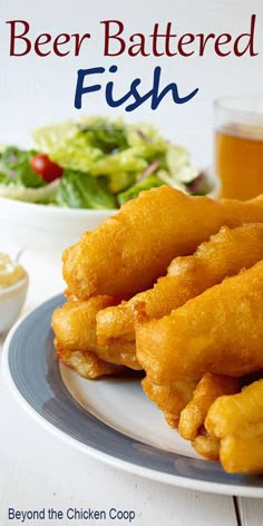 beer battered fish served on a plate with salad and drink in the backgroud