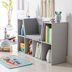 a child's room with bookshelves, toys and rugs on the floor