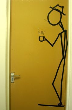 a door with a drawing of a man holding a coffee cup on it's side