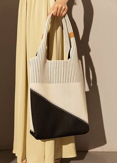 Indulge in sophistication and style with our Two Tone Canvas Colorblock Tote Bag. Made with premium canvas material, this handbag is the epitome of elegance and luxury. The two-tone design adds a touch of exclusivity, perfect for the fashionable woman on the go. Elevate your fashion game with this must-have accessory. Size info 11" (28cm) width 14 5/8"(37cm) height 4"(10cm) depth Details Open top Top carry handles Canvas Item #463001 Women's tote bag Chic Black Square Canvas Bag, Everyday Shoulder Bag With Contrast Color, Chic Black Canvas Satchel, Elegant Canvas Bag With Detachable Handle For Daily Use, Elegant Tote Canvas Bag For On-the-go, Chic Black Canvas Bag With Handles, Chic Shoulder Canvas Bag With Detachable Handle, Elegant Rectangular Canvas Bag, Everyday Contrast Color Shoulder Bag