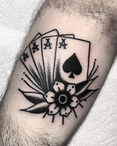 a man's arm with playing cards tattoo on it