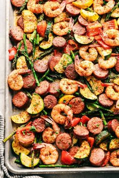 a pan filled with sausage, shrimp and veggies