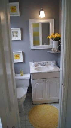 a white sink sitting under a mirror in a bathroom next to a toilet and bathtub