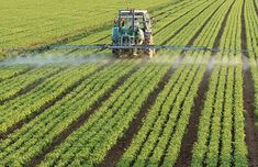 a tractor spraying pesticide on a field