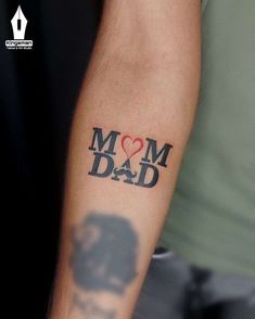 a man with a tattoo on his arm that says mom dad