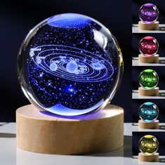 a glass ball with an image of the solar system inside it on a wooden stand