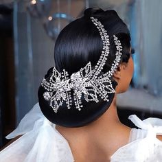 a woman with black hair wearing a bridal headpiece