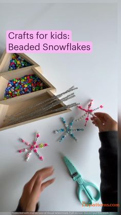 a person is making beaded snowflakes out of wood