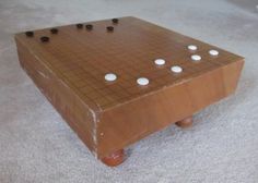 a wooden board game sitting on top of a white carpet