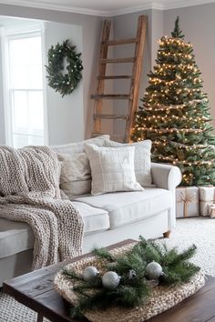 a living room decorated for christmas with a ladder and tree in the corner, surrounded by greenery