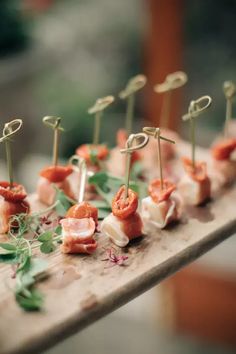 small appetizers are arranged on a wooden table