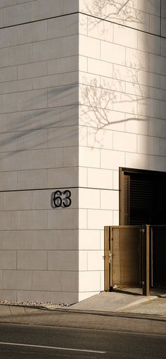 a building with the number 55 on it and a street sign in front of it