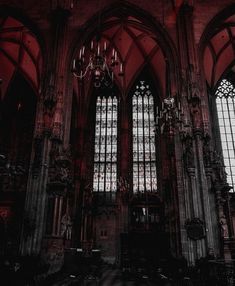 an old church with stained glass windows and chandeliers