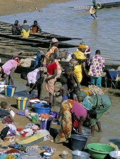 many people are washing clothes in the water