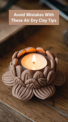 a candle sitting on top of a wooden table next to a box with the words avoid mists with these air dry clay tips