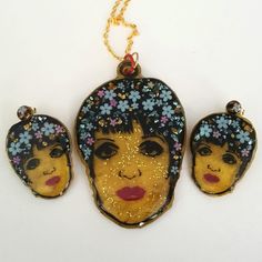 Liza Minnelli Necklace And Earrings,  Liza Resin Jewelry, Icon, Resin Art THE NECKLACE AND EARRINGS ARE SOLD SEPERATELY This set is completely handmade. You will receive the exact set that is pictured. This is a unique design for Rock My World, Inc. This is an art piece of Liza.  That is a little glitter on her face. It does not photograph to well, but in person is subtle. This piece is made with layers and layers of resin and fun inclusions. You will never see this anywhere else. It is all hand Jewelry Icon, Liza Minnelli, Large Necklace, Necklace And Earrings, My World, Stainless Steel Rings, Steel Ring, Resin Jewelry, Resin Art